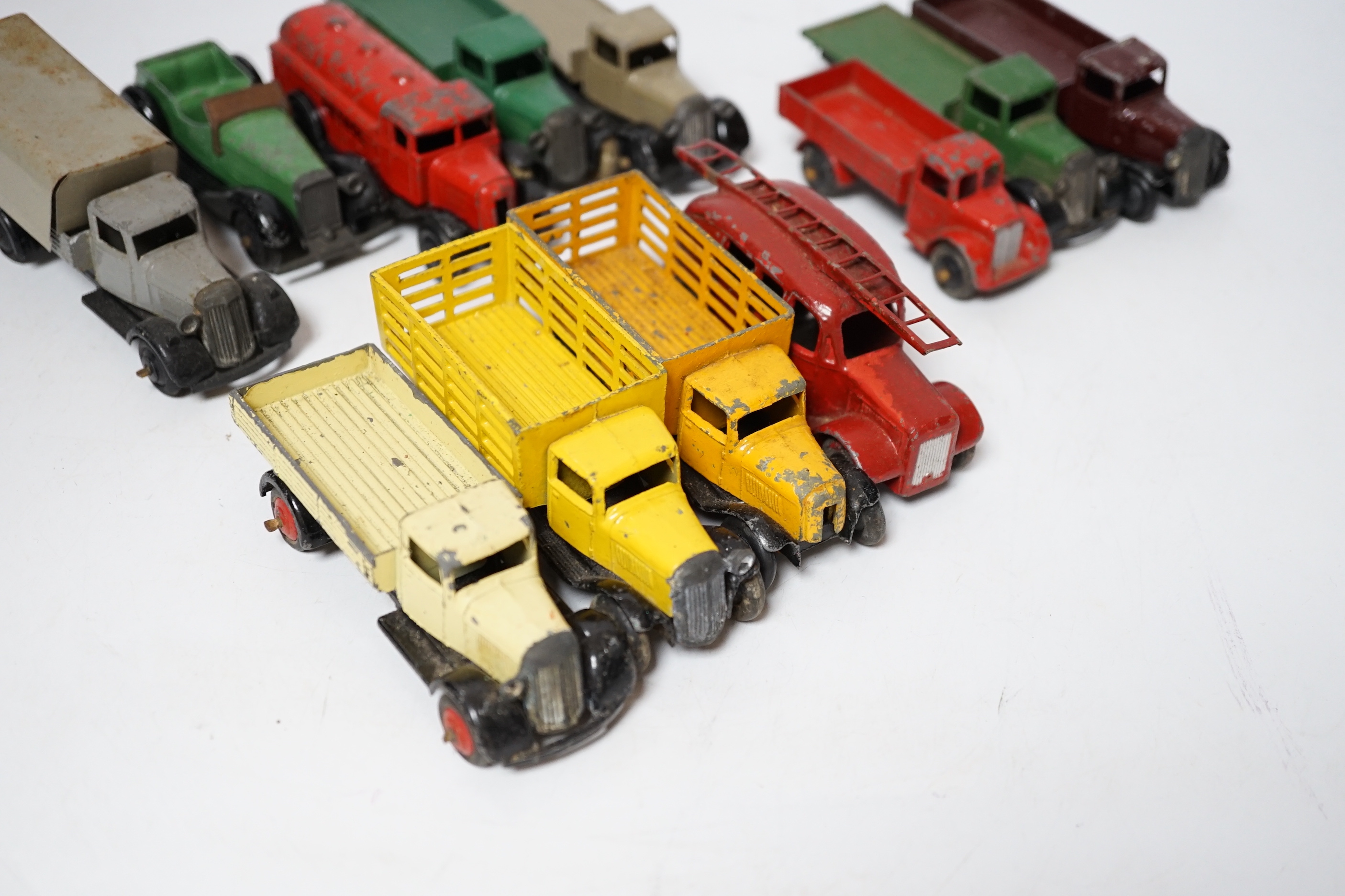 Twenty-five Dinky Toys and Atlas Dinky including a few pre-war examples; Delivery lorries, Market Gardener’s wagon, a Streamlined Fire Engine, a Jaguar SS, Mechanical Horse, etc. together with five Atlas stinky, includin